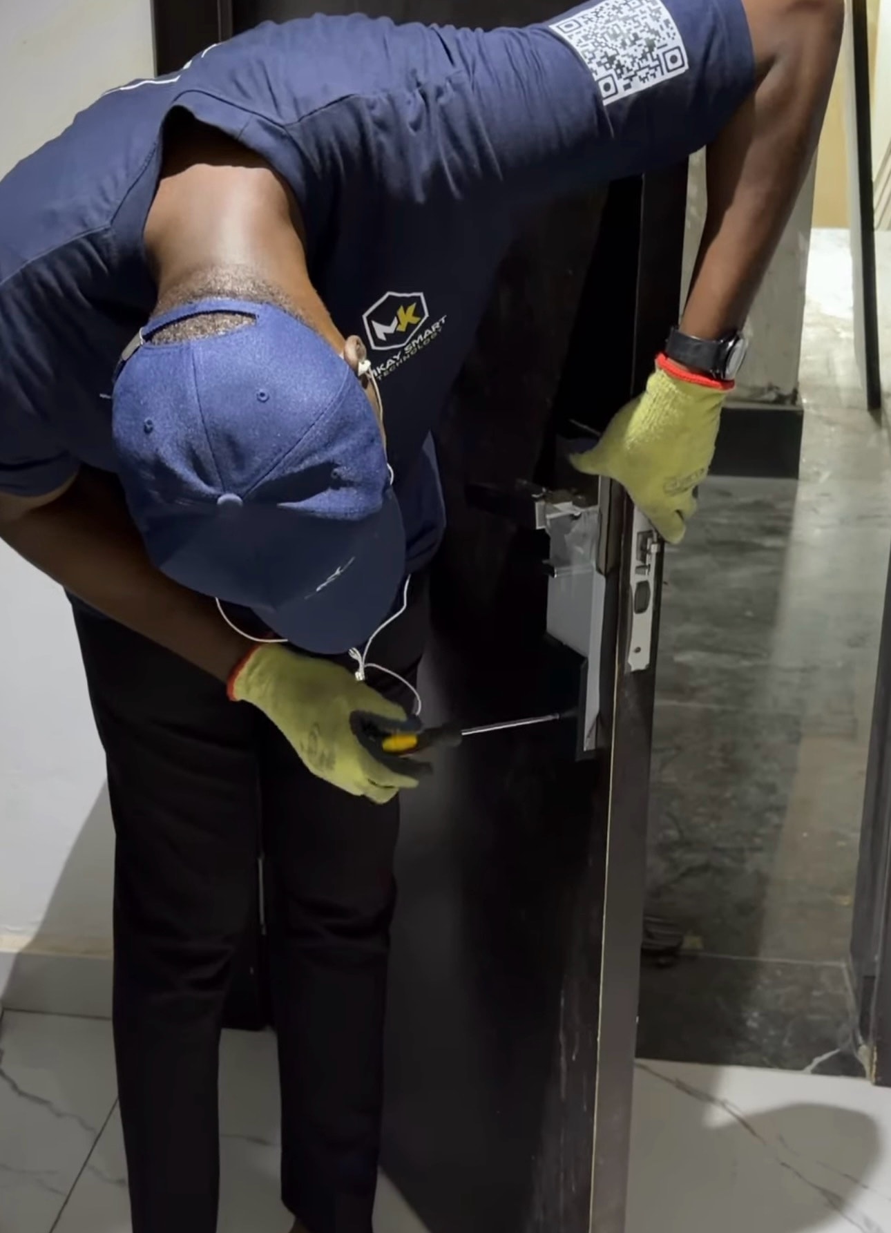 MKay technician professionally installing smart lock on door
